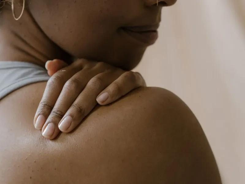 Woman holding shoulder