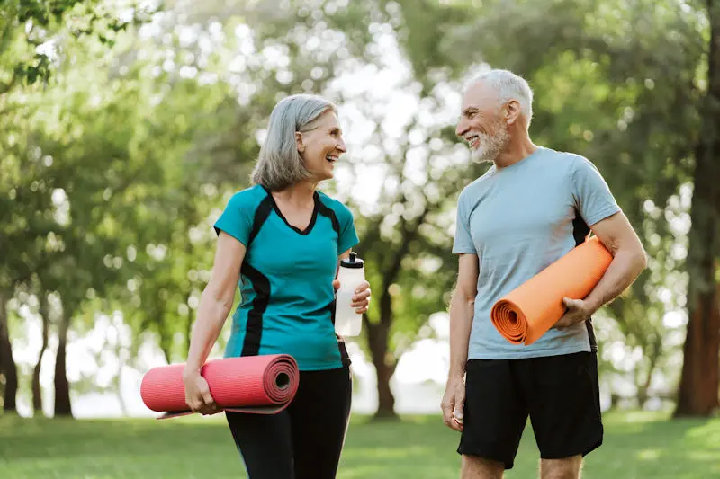 Older couple with yoga mats