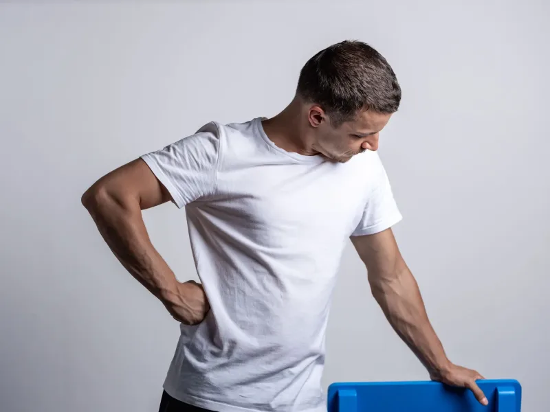 Man holding back in pain